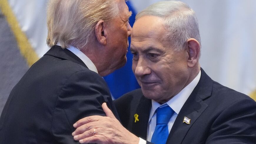 US President Donald Trump talks with Israeli Prime Minister Benjamin Netanyahu in the Knesset, Jerusalem, Oct. 13, 2025.