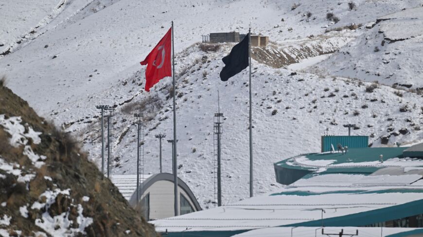 This photograph shows a Turkish national flag at the Razi-Kapikoy border crossing with Iran next to a black flag on the Iranian side, following the death of Iranian Supreme Leader Ayatollah Ali Khamenei, in eastern Turkey on March 2, 2026. 