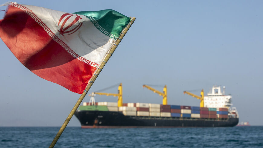 An Iranian flag flutters in the wind as ships remain anchored on May 16, 2026 in the Strait of Hormuz near Larak Island, Iran.  