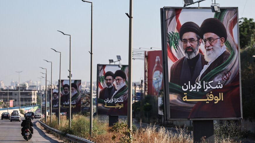 Cars drive past billboards showing Iran's new Supreme Leader Ayatollah Mojtaba Khamenei (L) and his late father Ali Khamenei (R), with the slogan "Thank you, loyal Iran," erected along the highway leading to Rafik Hariri International Airport, Beirut, Lebanon, June 22, 2026.