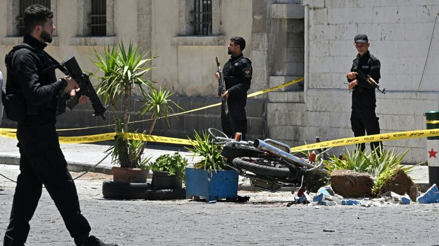 Two blasts hit central Damascus on Tuesday, killing one person and wounding dozens during the French president's first visit to Syria