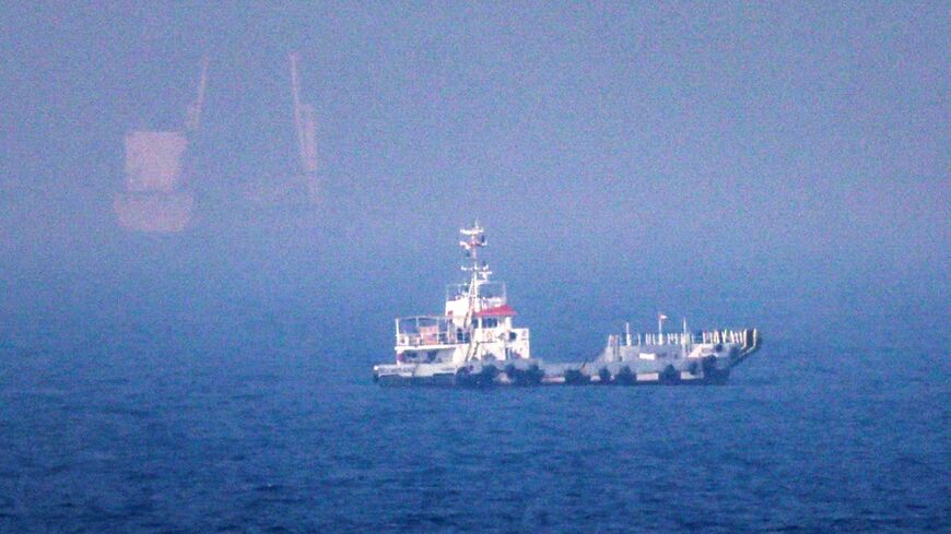 Ships sail near the Strait of Hormuz off the eastern coast of the United Arab Emirates at Khor Fakkan on July 13, 2026