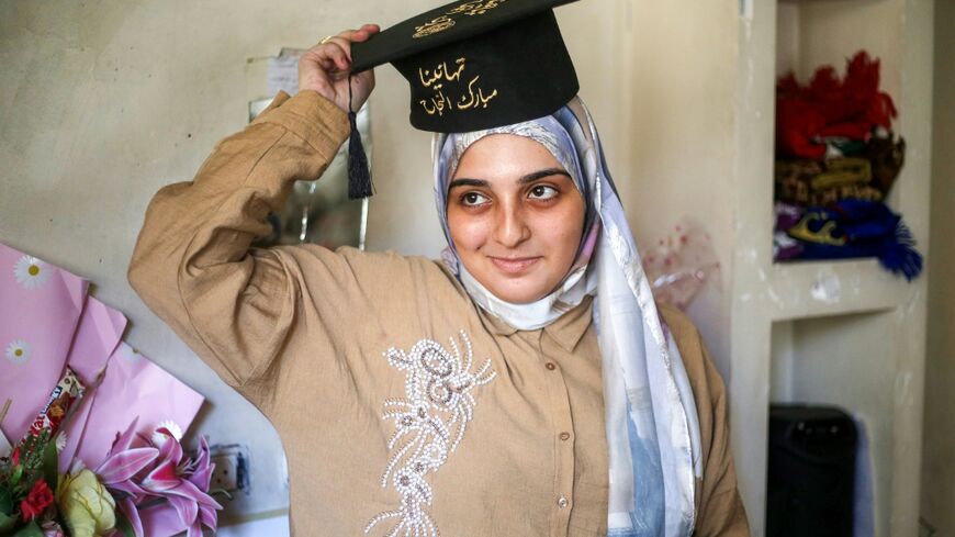 Palestinian student Saba Rabah celebrates with family at the Maghazi camp for Palestinian refugees in the central Gaza Strip