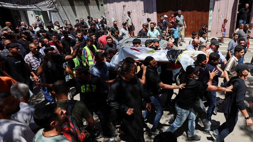 Mourners carry the body of Palestinian man Mohammad al-Waheidi, who worked for the Egyptian Relief Committee and was killed in an Israeli strike on Tuesday, during his funeral, in Gaza City, July 8, 2026. REUTERS/Dawoud Abu Alkas