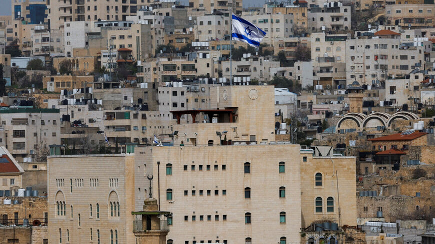 FILE PHOTO: An Israeli flag flies over an Israeli settlement in the old city in Hebron in the Israeli-occupied West Bank, February 9, 2026. REUTERS/Mussa Qawasma/File Photo