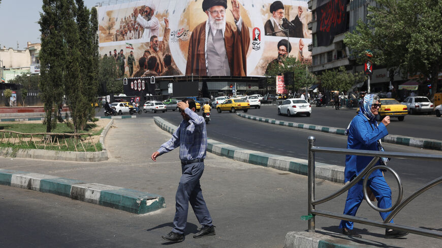 People walk past a billboard featuring images of Iran's late Supreme Leader Ayatollah Ali Khamenei in Tehran, Iran, July 13, 2026. Majid Asgaripour/WANA (West Asia News Agency) via REUTERS