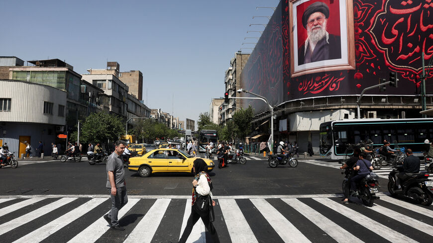 People walk past a billboard with an image of Iran's late Supreme Leader Ayatollah Ali Khamenei in Tehran, Iran, July 13, 2026. Majid Asgaripour/WANA (West Asia News Agency) via REUTERS