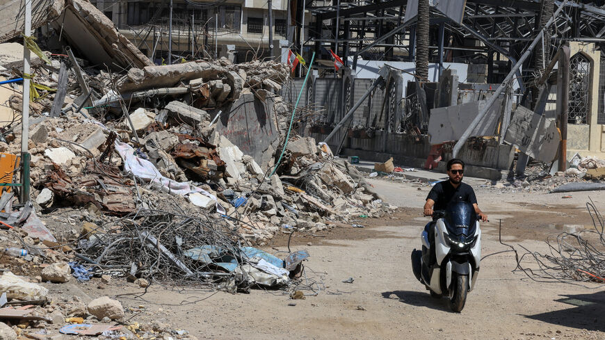 FILE PHOTO: A man rides past the rubble of buildings damaged in Israeli strikes in Beirut’s southern suburbs in Beirut, Lebanon, July 6, 2026. REUTERS/Mohamed Azakir