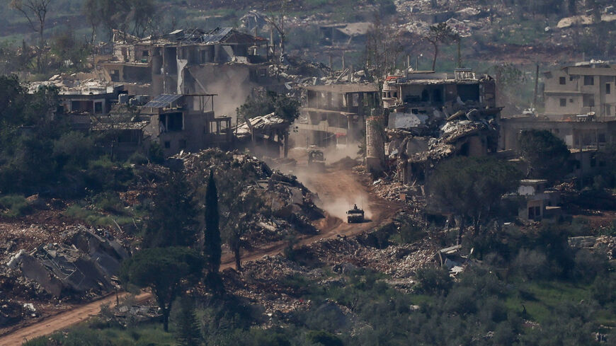 FILE PHOTO: An Israeli military vehicle drives past destroyed buildings in Lebanon, as seen from the Israeli side of the Israel-Lebanon border, April 30, 2026. REUTERS/Shir Torem/File Photo