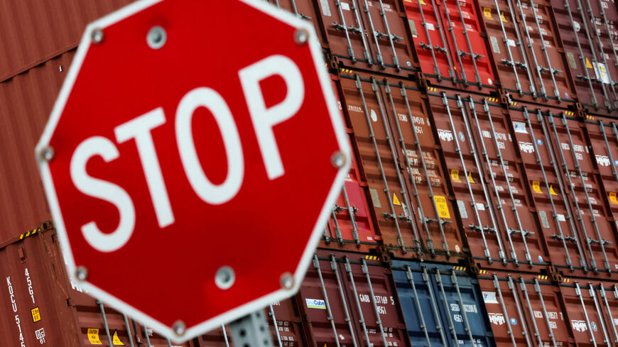 FILE PHOTO: A stop sign is pictured in front of shipping containers at the Port of Long Beach in Long Beach, California, U.S., July 11, 2025. REUTERS/Daniel Cole/File Photo