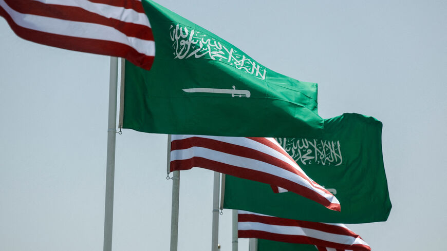 FILE PHOTO: U.S. and Saudi flags flutter along a highway of Riyadh, as pictured through the glass of a car, ahead of the arrival of U.S. President Donald Trump to Riyadh, Saudi Arabia May 12, 2025. REUTERS/Hamad I Mohammed/File Photo