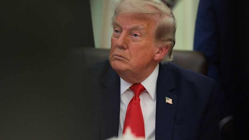 U.S. President Donald Trump sits behind an airport model as he makes an announcement about a $22.5 billion renovation of Washington Dulles International Airport with U.S. Secretary of Transportation Sean Duffy (not pictured) in the Oval Office at the White House in Washington, D.C., U.S., July 29, 2026. REUTERS/Kylie Cooper