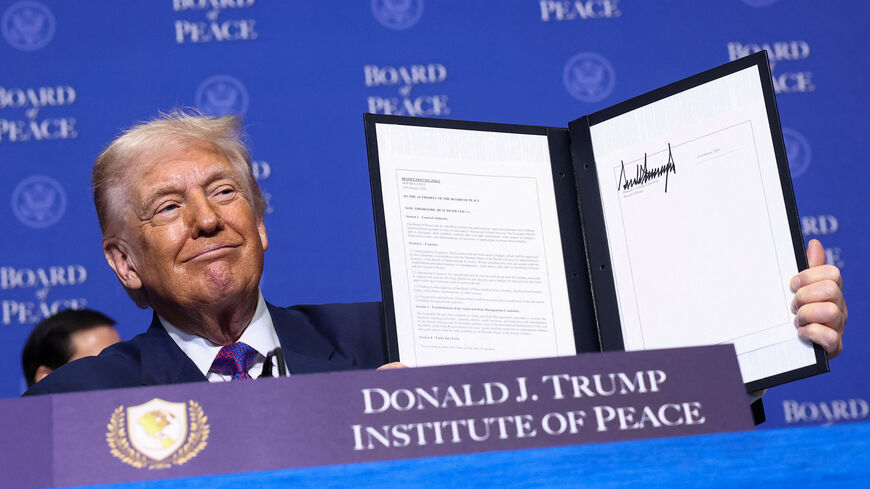 U.S President Donald Trump holds a signed resolution, during the inaugural Board of Peace meeting at the U.S. Institute of Peace in Washington, D.C., U.S., February 19, 2026. REUTERS/Kevin Lamarque