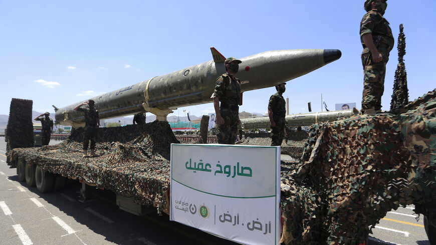 Houthi soldiers stand guard on a missile carrier during an official military parade marking the ninth anniversary of the Houthi takeover of the capital, Sanaa, on Sept. 21, 2023.
