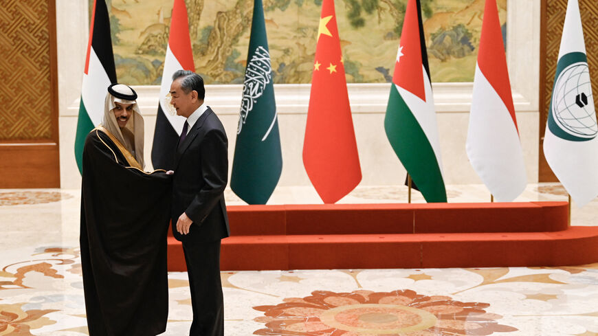 China's Foreign Minister Wang Yi (R) shakes hands with Saudi Arabia's Foreign Minister Prince Faisal bin Farhan Al-Saud before a family photo for the attendees of a meeting of foreign ministers from Arab and Muslim-majority nations at the Diaoyutai State Guest House in Beijing on November 20, 2023. The international community must take urgent action to stop the "humanitarian disaster" unfolding in Gaza, Chinese Foreign Minister Wang Yi told visiting diplomats from Arab and Muslim-majority nations on Novembe
