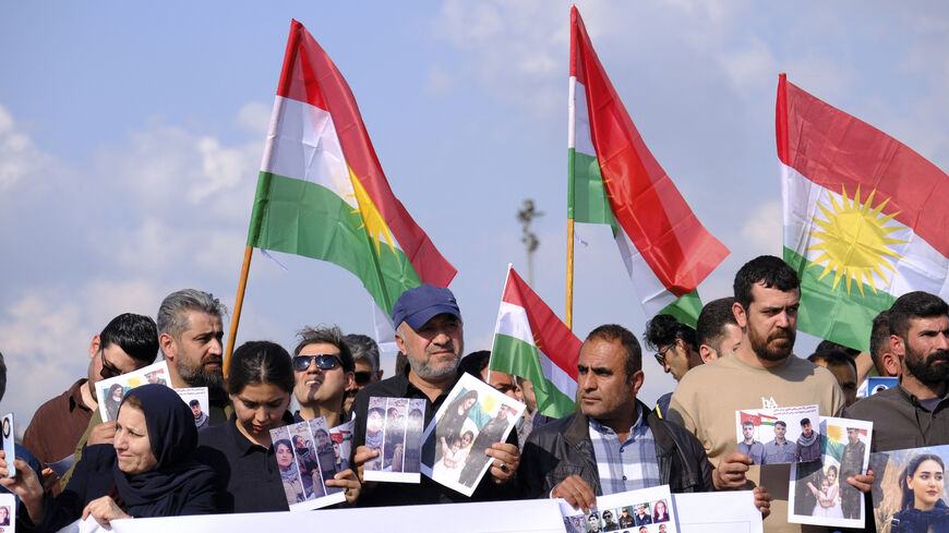 People wave flags of Kurdistan during a march in Erbil, Iraq, on April 21, 2026, expressing support for the unity of Iranian Kurdish parties and condemning Iranian missile strikes and military actions against Kurdish groups in the Kurdistan Region of Iraq. 