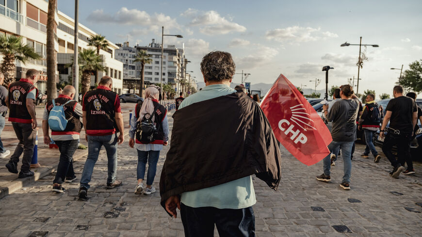 A demonstrator carries a CHP flag during a protest in Izmir, Turkey, on May 24, 2026. 