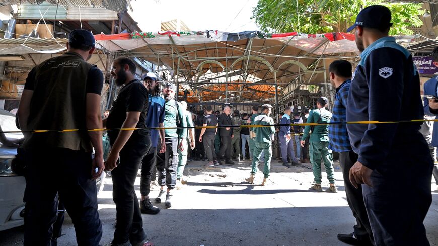 Syrian security forces and people gather at the site of an explosion at a cafe in the capital, Damascus, on July 2, 2026. 