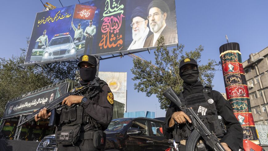 Iranian NOPO special police officers stand guard in front of a large portrait of Iran's late Supreme Leader, Ayatollah Ali Khamenei, at Valiasr square on July 3, 2026, in Tehran, Iran. 