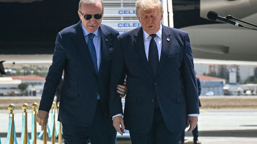 Turkish President Recep Tayyip Erdogan (L) welcomes US President Donald Trump (R) upon his arrival on Air Force One at Etimesgut Air Base near Ankara, on July 7, 2026, before attending the 36th NATO Heads of State and Government Summit. (Photo by SAUL LOEB / AFP via Getty Images)