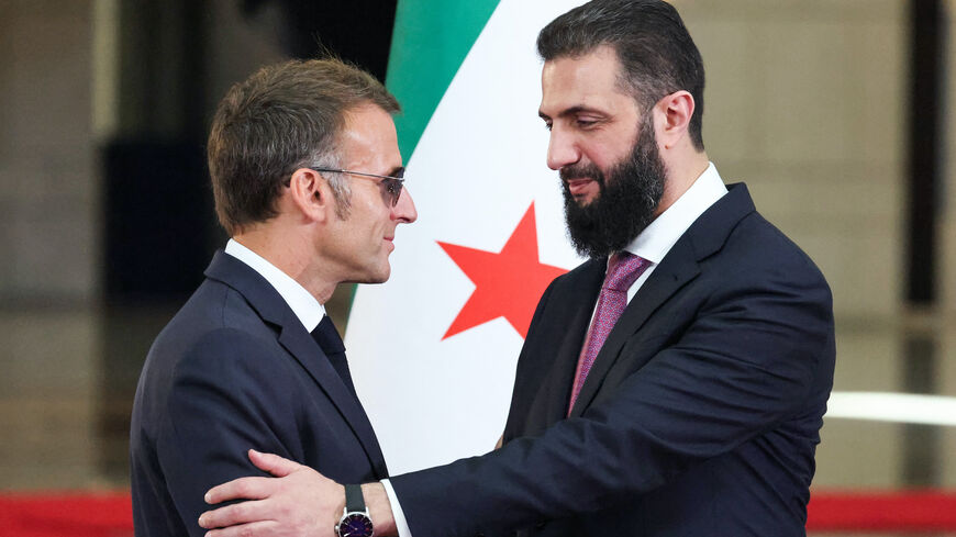 Syrian President Ahmed al-Sharaa (R) shakes hands with France's President Emmanuel Macron following a joint press conference in Damascus on July 7, 2026. 