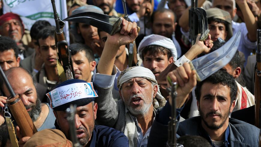 Armed Yemeni supporters of the Iran-backed Houthi movement brandish their weapons during a protest against US strikes on Iran in Sanaa on July 10, 2026. 