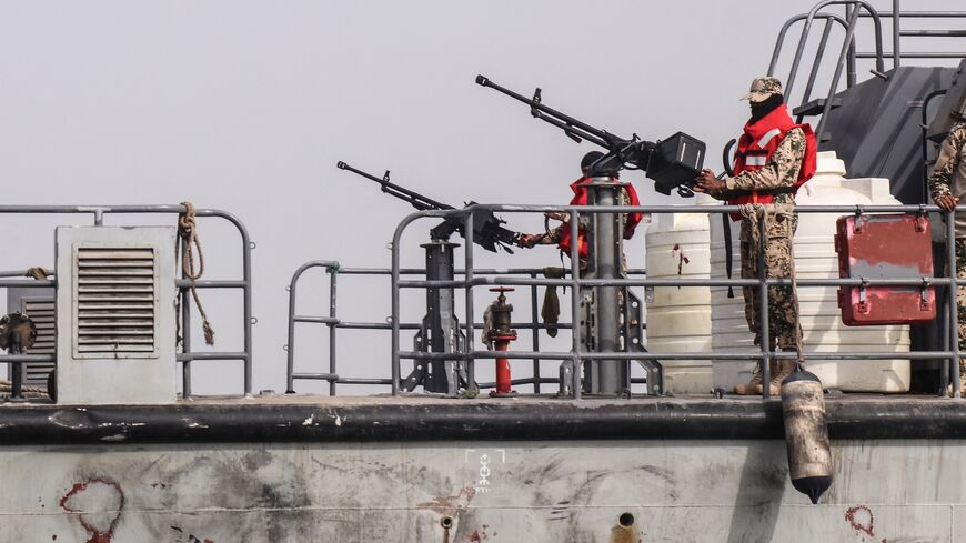 Sailors from the navy of Yemen's Aden-based internationally recognized government stand at machine-gun positions aboard a vessel patrolling a shipping lane off Hanish Island in the Red Sea on July 27, 2026. 