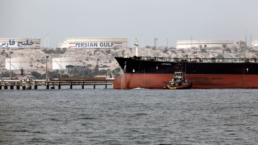 A picture taken on March 12, 2017, shows an Iranian tanker docking at the platform of the oil facility in the Khark Island, on the shore of the Gulf. 
