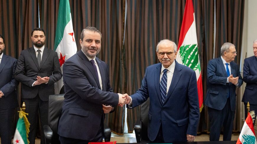 Nawaf Salam and Asaad al-Shibani shake hands in Beirut on July 2, 2026. 