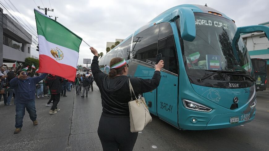 Fans cheer for Iran's World Cup team as they leave their base camp in Tijuana, Mexico