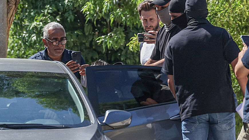Police officers wearing balaclavas escort a man suspected of killing a British tourist to a car, after he appeared before a prosecutor in a court in Athens, Greece, August 5, 2026. REUTERS/Louisa Gouliamaki