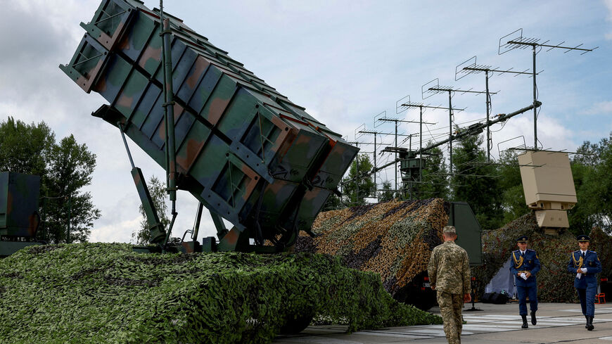 FILE PHOTO: FILE PHOTO: Ukrainian service members walk next to a launcher of a Patriot air defence system, amid Russia's attack on Ukraine, in an undisclosed location, Ukraine August 4, 2024. REUTERS/Valentyn Ogirenko/File Photo
