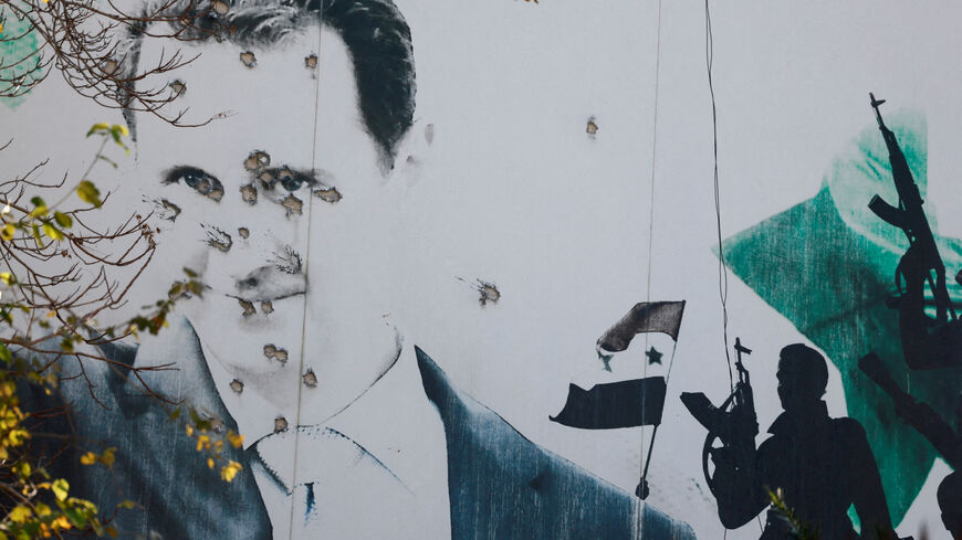 FILE PHOTO: A billboard with a picture of Syria's Bashar al-Assad shows damage by bullet holes, after the ousting of Syria's Bashar al-Assad, in Damascus, Syria, December 16, 2024. REUTERS/Ammar Awad/File Photo