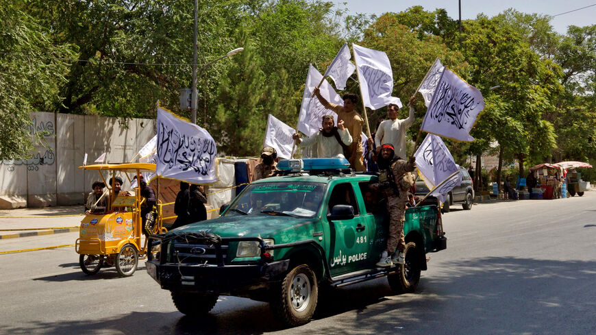FILE PHOTO: Members of the Taliban carrying flags participate in a rally to mark the third anniversary of the fall of Kabul, in Kabul, Afghanistan, August 14, 2024. REUTERS/Sayed Hassib/File Photo