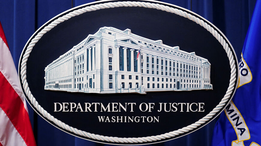 A U.S. Justice Department logo or seal showing Justice Department headquarters, known as "Main Justice," is seen behind the podium in the Department's headquarters briefing room before a news conference with the Attorney General in Washington, January 24, 2023.  REUTERS/Kevin Lamarque