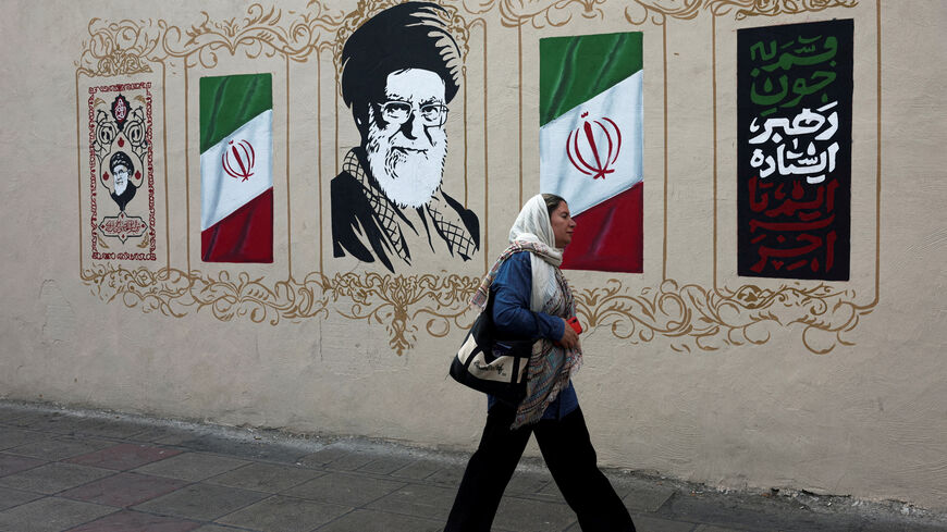 FILE PHOTO: A woman walks by a mural depicting Iran's late Supreme Leader Ayatollah Ali Khamenei, on a street in Tehran, Iran, August 13, 2026. Majid Asgaripour/WANA (West Asia News Agency) via REUTERS/File Photo