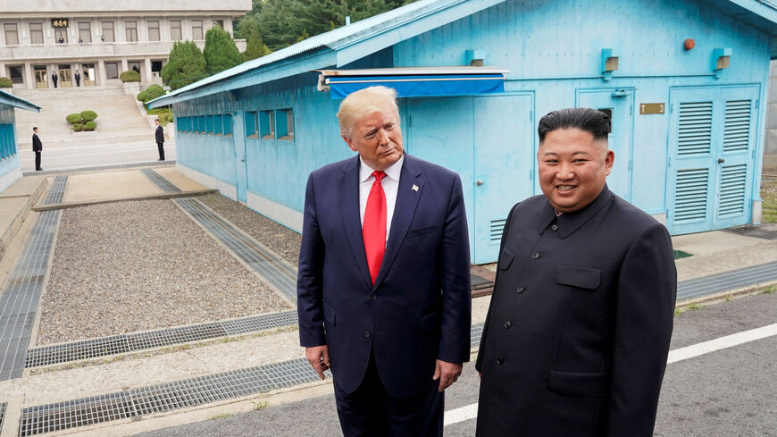 FILE PHOTO: U.S. President Donald Trump meets with North Korean leader Kim Jong Un at the demilitarized zone separating the two Koreas, in Panmunjom, South Korea, June 30, 2019. REUTERS/Kevin Lamarque/File Photo