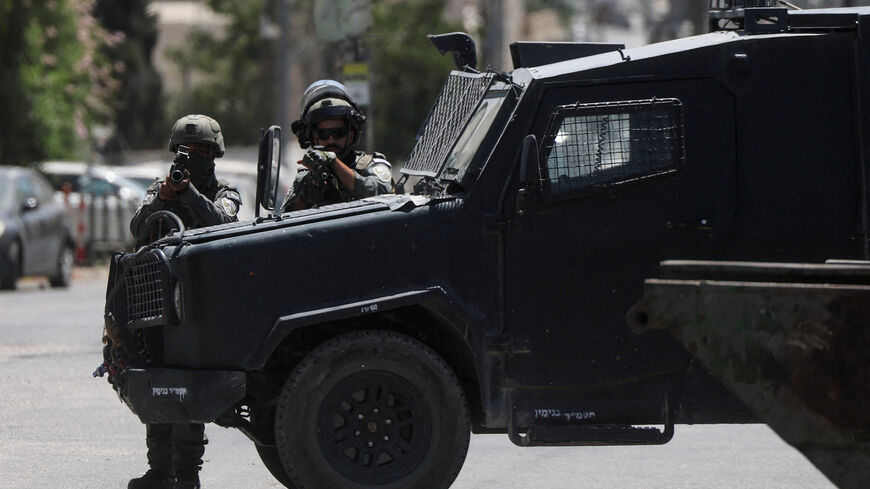 FILE PHOTO: Israeli forces point their weapons as they take part in a raid in Qalandia refugee camp, in the Israeli-occupied West Bank, August 25, 2026. REUTERS/Ammar Awad/File Photo