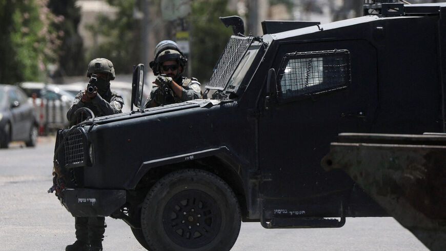 FILE PHOTO: Israeli forces point their weapons as they take part in a raid in Qalandia refugee camp, in the Israeli-occupied West Bank, August 25, 2026. REUTERS/Ammar Awad/File Photo — Ammar Awad
