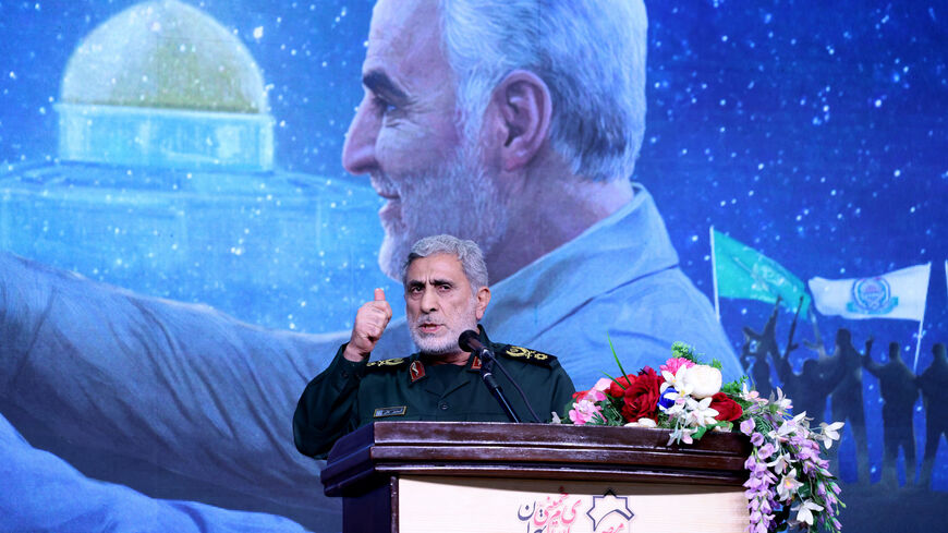 The commander of the Quds Force of the Islamic Revolutionary Guard Corps, Esmail Qaani, speaks during a commemoration ceremony marking the anniversary of the 2020 killing of Guards general Qasem Soleimani (on screen) in the capital Tehran on Jan. 3, 2024. 