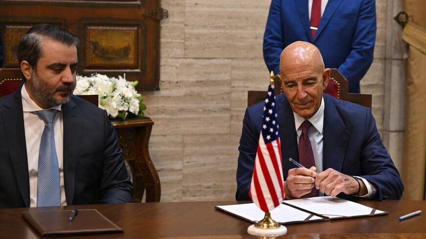 Syrian Foreign Minister Asaad al-Shaibani (C) watches as US special envoy for Syria Tom Barrack prepares to sign an agreement in Damascus on September 16, 2025. Shaibani announced on September 16 a plan backed by Jordan and the United States to restore calm to Druze-majority Sweida province, which witnessed deadly violence in July. (Photo by LOUAI BESHARA / AFP) (Photo by LOUAI BESHARA/AFP via Getty Images)