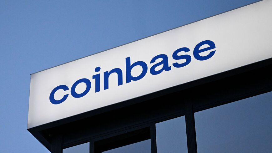 This photograph taken on Jan. 21, 2026, shows signage of the Coinbase logo during the World Economic Forum meeting in Davos. — INA FASSBENDER / AFP via Getty Images
