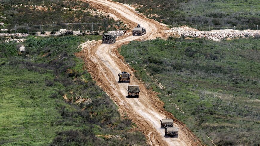 Israeli army vehicles move to a position in southern Lebanon, March 27, 2026.