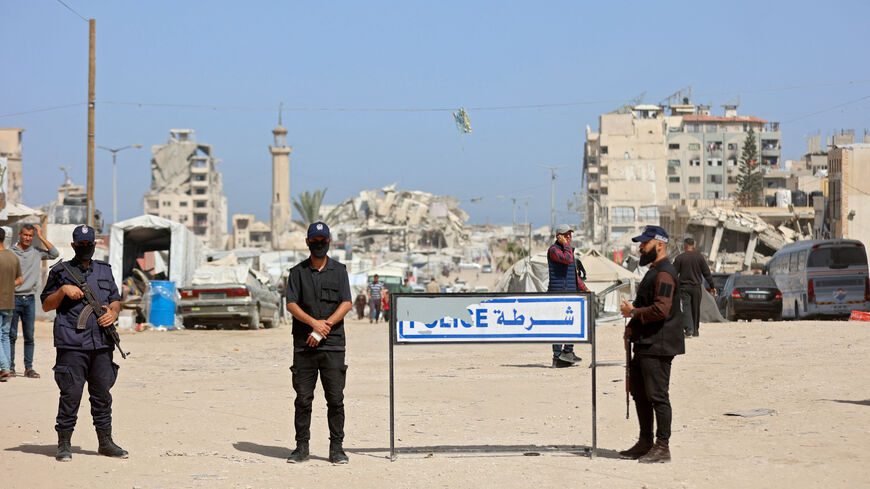 Palestinian militant group Hamas police officers stand guard as people attend the opening of the Fatah party's eighth general conference at Al-Azhar University in Gaza City on May 14, 2026. 