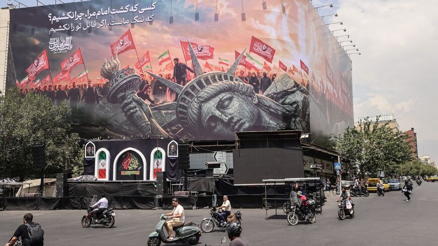 Iranians drive past an anti-US billboard at Enghelab Square in central Tehran, Aug. 3, 2026. — ATTA KENARE / AFP via Getty Images