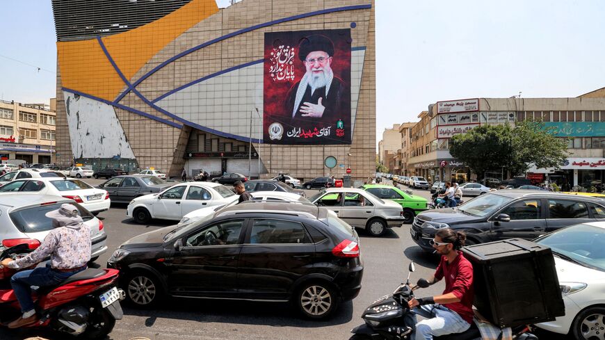 Motorists drive vehicles past a billboard depicting Iran's late supreme leader Ali Khamenei along a street in central Tehran on August 8, 2026. Hopes for an imminent US-Iran deal to end the blockage of the Strait of Hormuz added to optimism that oil and gas, along with other key products, would again start flowing freely after more than five months of war. But oil prices turned higher ahead of the weekend in the absence of any confirmation of an accord, amid reports that Iran was planning to block US and Is