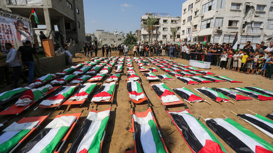 People attend a mass funeral for members of the Abu Sharia and Al-Hasayna families, whose remains were recently recovered from the rubble of their homes after an attack earlier in the war, on Aug. 4, 2026 in the Sabra neighborhood of Gaza City, Gaza. 