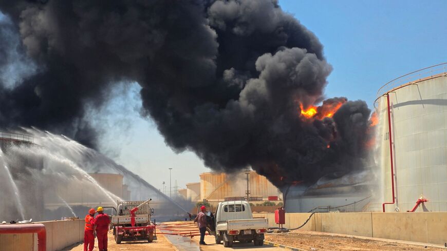 Libyan firefighting teams attempt to extinguish a fire at the Zawiya refinery, the second-largest oil refinery in Libya, with a refining capacity of 120,000 barrels per day, after a tank belonging to the state-owned Libyan Brega Oil Company was attacked by unknown perpetrators, in Zawiya, Libya, on Aug. 11, 2026.