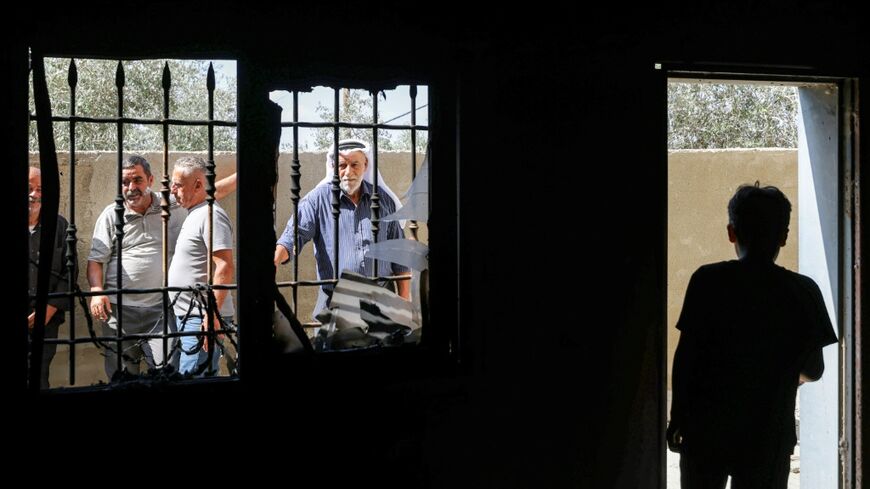 People inspect a mosque that was allegedly attacked by Israeli settlers in the Palestinian village of Bazzaryah, in the Israeli-occupied West Bank