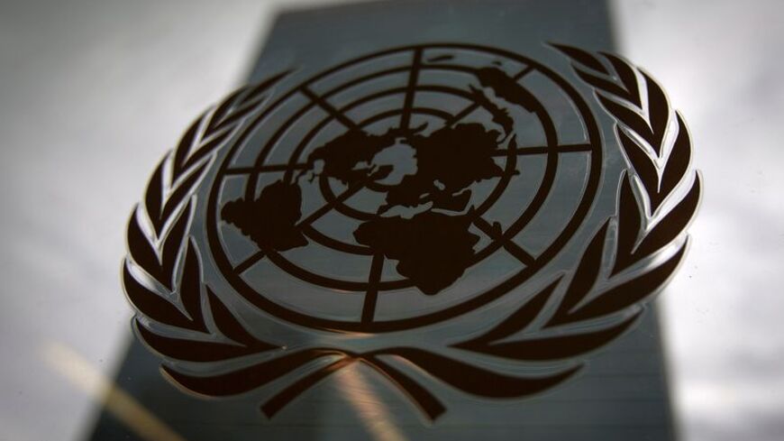 FILE PHOTO: The United Nations headquarters building is pictured though a window with the UN logo in the foreground in the Manhattan borough of New York